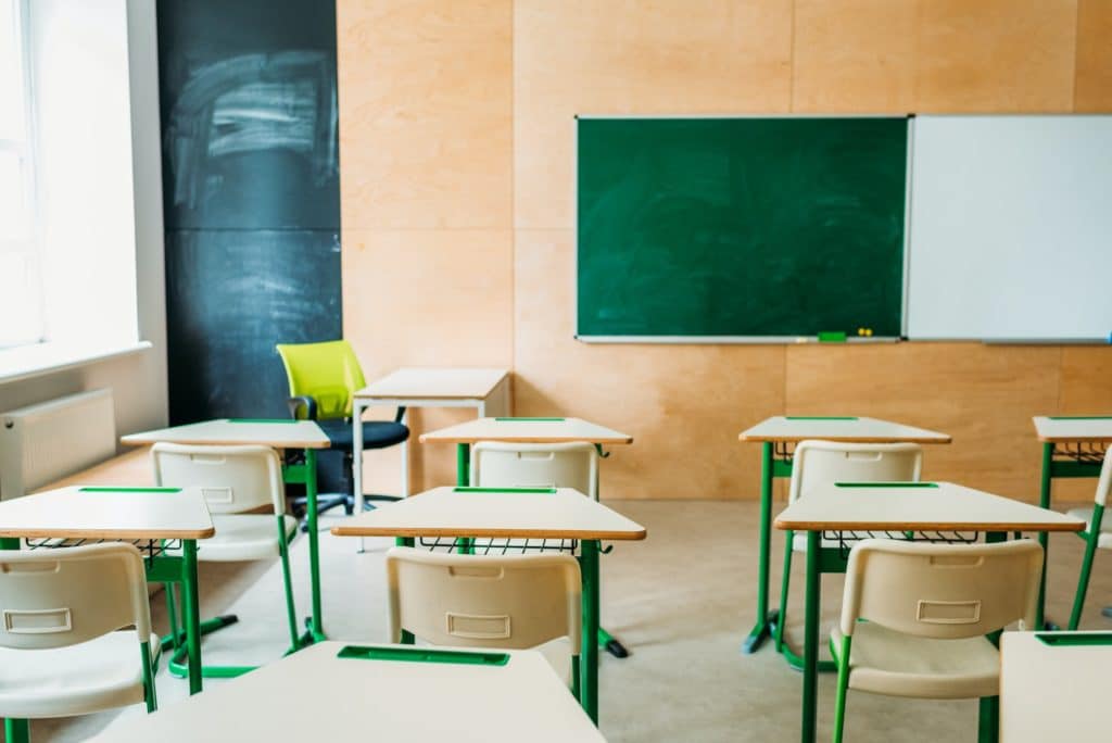 interior of empty modern classroom with blank chalkboard at school