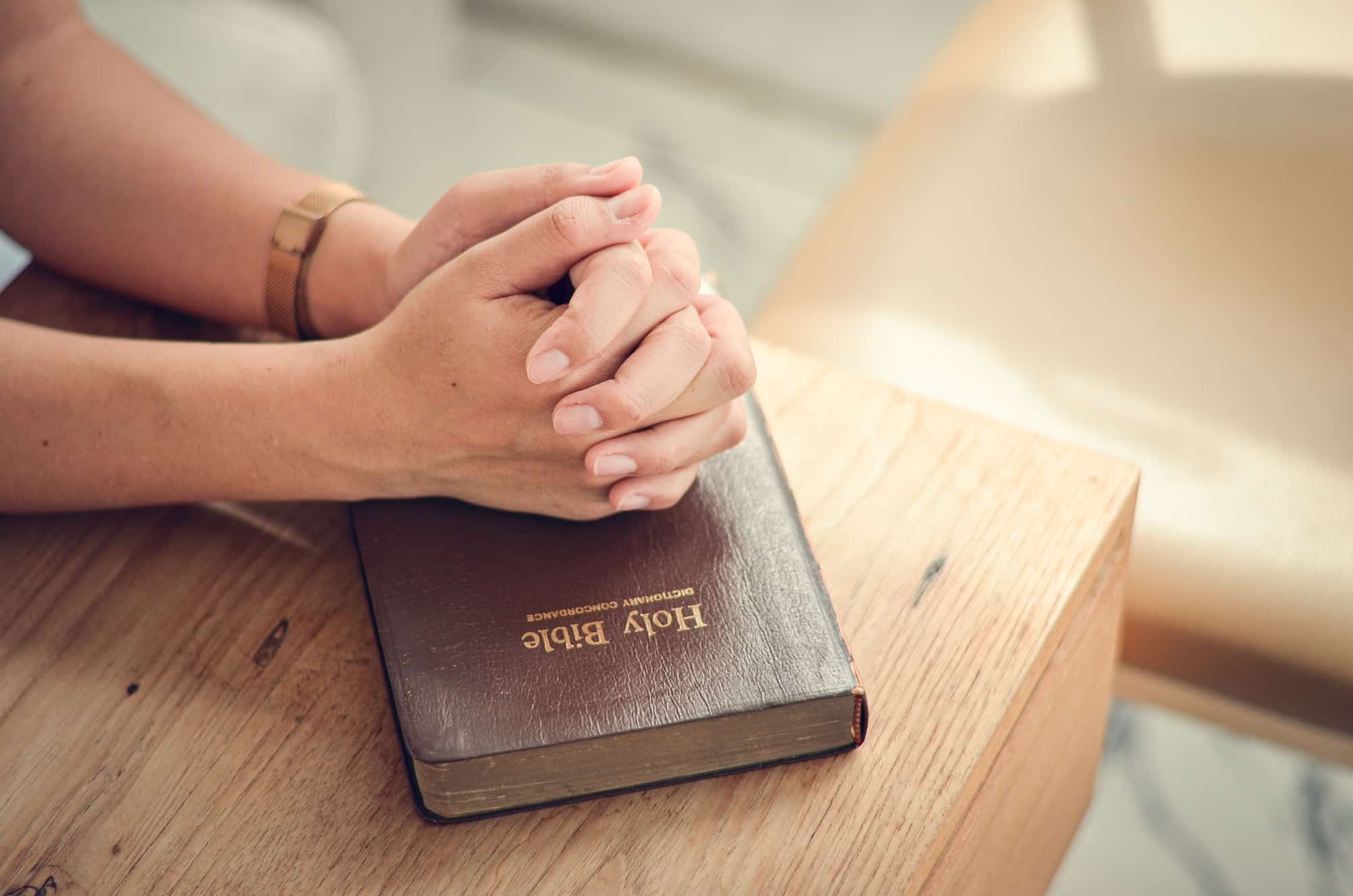 Sitting with biblical prayer, fold your hands in biblical, spiritual and religious prayer. Communica