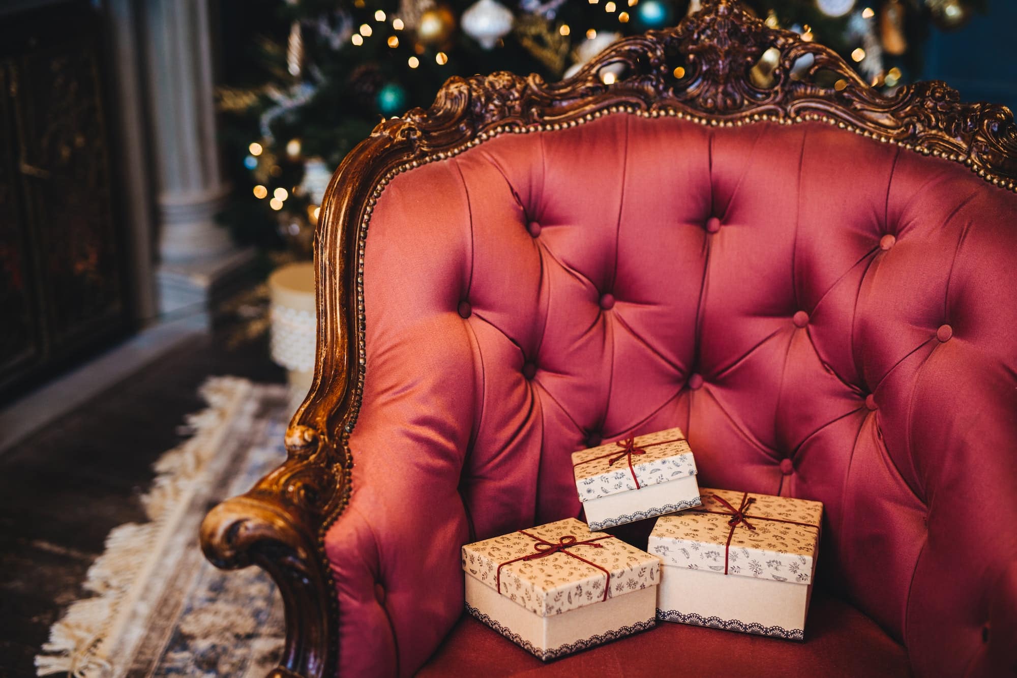 Wrapped three gift boxes on beautiful royal armchair indoors